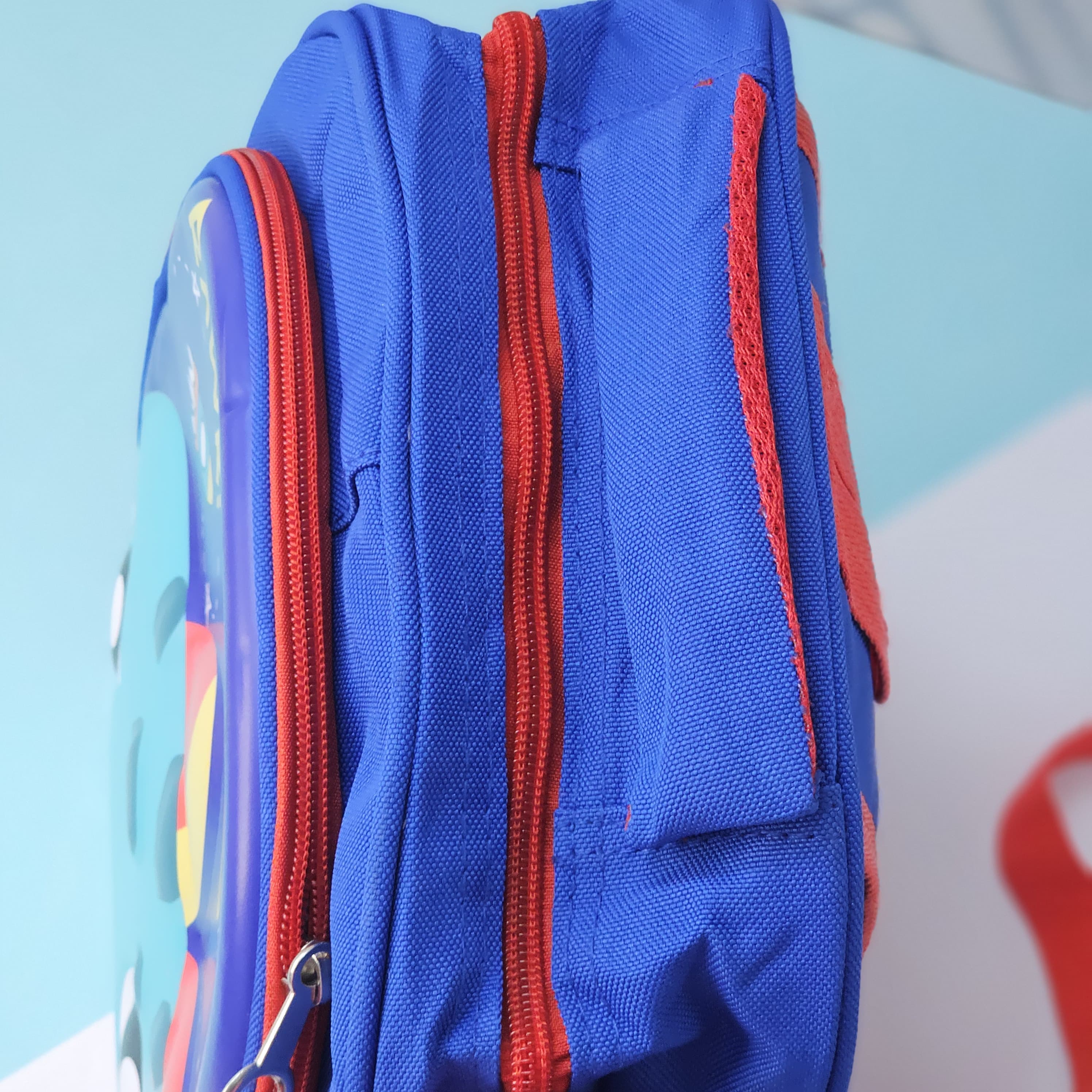 "Close-up of a Usmile Toys children's cartoon school backpack, designed in pink with a playful unicorn character on the front panel, and a matching pink water bottle in the side mesh pocket." www.usmile.toys
